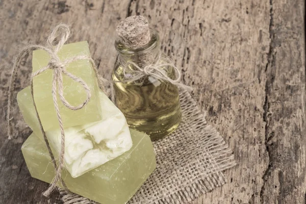natural olive oil soap bars and olive oil bottle on wooden table