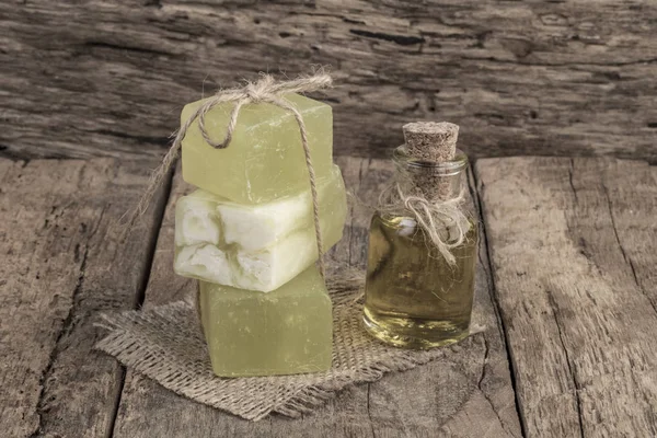 natural olive oil soap bars and oil bottle on wooden table