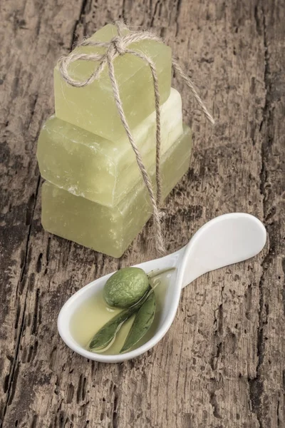 natural olive oil soap and olive on wooden table