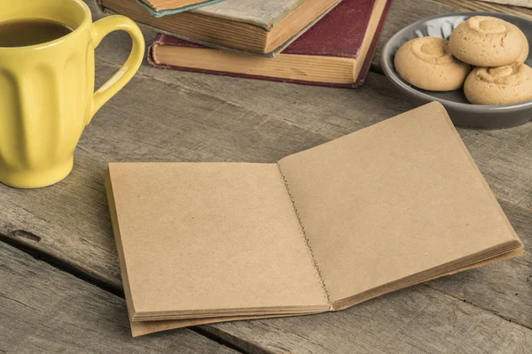 Un cuaderno en blanco y café sobre una mesa de madera — Foto de Stock