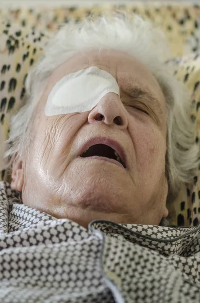 Una persona mayor con vendaje ocular después de una operación de catarata Imagen De Stock