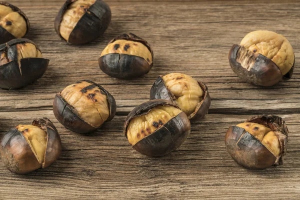 Roasted chestnuts on a wooden table — Stock Photo, Image