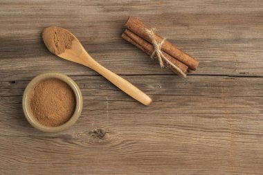 Tarçın tozu ve sopalar kopyalama alanı olan ahşap bir masada.