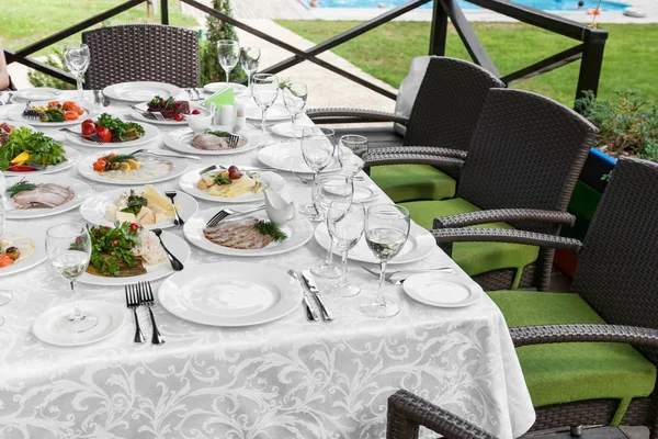 Cutlery, snacks on festive table — Stock Photo, Image