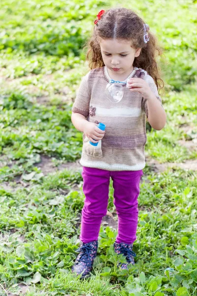 Portrait of little girl blow bubbles — Stock Photo, Image