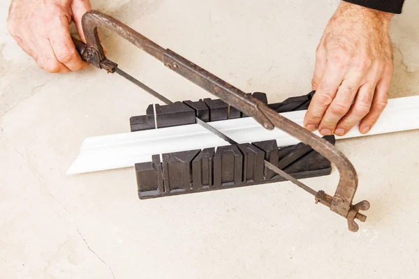 Cutting ceiling skirting in miter box — Stock Photo, Image