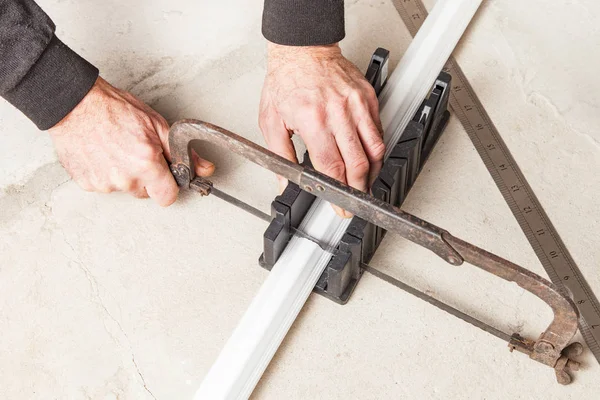 Cutting ceiling skirting in miter box — Stock Photo, Image