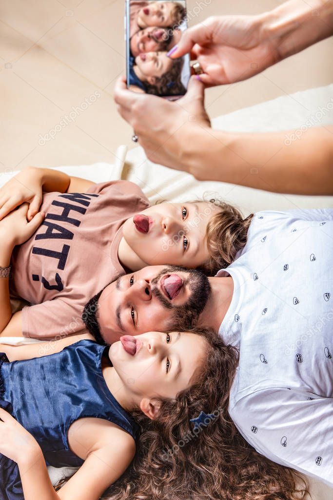 Mom photographs her family on a smartphone