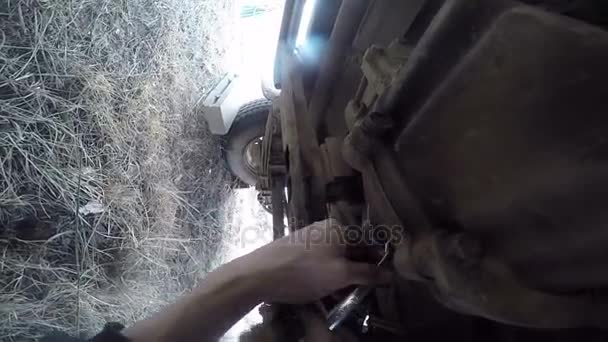 POV debajo del eje de la hélice de reparación del hombre del coche — Vídeos de Stock