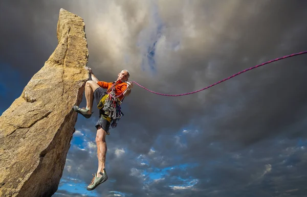 Climber on the edge. Royalty Free Stock Photos