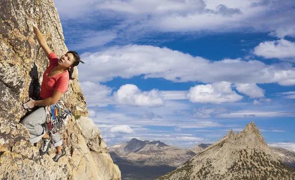 Rock climber clinging to a cliff. Stock Photo