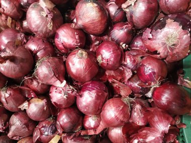 Tezgahta bir sürü kırmızı soğan var.