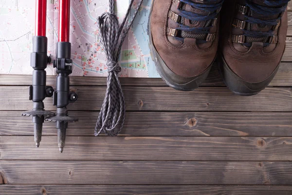 Equipment for hiking on a wooden floor background. — Stock Photo, Image