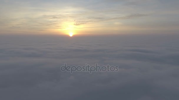 Scenic flight above the clouds towards the sun. — Stock Video