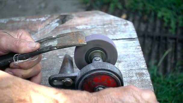 The worker sharpens the tool. Work on a sharpening machine. — Stock Video