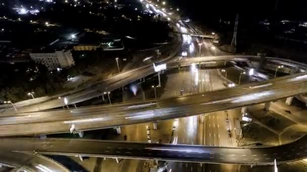 Vista aérea vertical de arriba hacia abajo del tráfico en el intercambio de la autopista por la noche . — Vídeo de stock