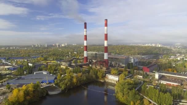 Flying over the pipes of the plant from which the smoke goes — Stock Video