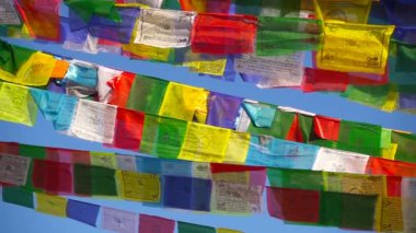 Budist dua bayrakları dalga rüzgarda, yakın çekim.