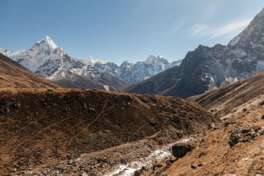 Ama Dablam dağ. Güneş yamaçlarda aydınlatır. Himalaya Dağları, Nepal.