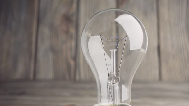 Light bulb on wood background — Stock Video