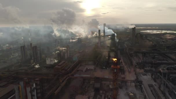 Steel factory pipes during sunrise time. high above metallurgical plant and smoke cloud is coming from chimney — Stock Video