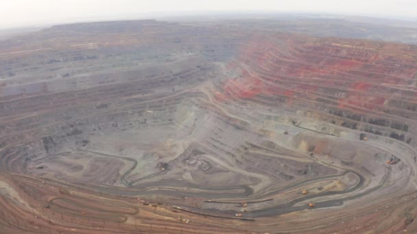 Aerial view of opencast mining quarry with lots of machinery at work — Stock Footage Aerial view of opencast mining quarry with lots of machinery at work Royalty Free Stock Footage