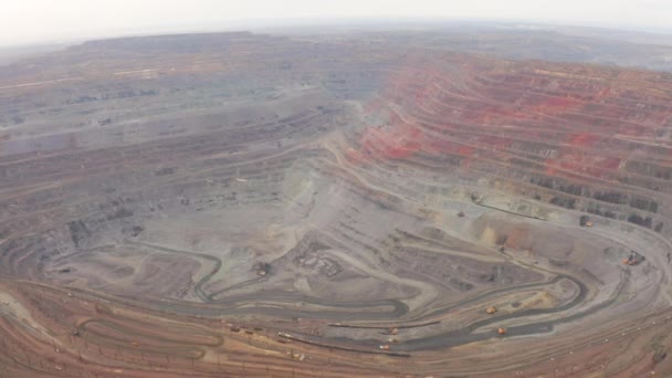 Aerial view of opencast mining quarry with lots of machinery at work — Stock Video