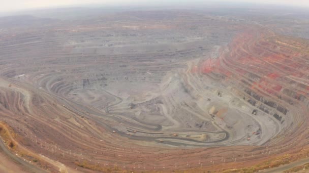 Aerial view of opencast mining quarry with lots of machinery at work — Stock Video