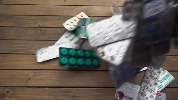 Closeup shot of different pills falling on table, pharmaceutical industry concept. — Stock Video