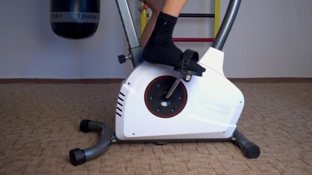 Gym exercising on stationary bike. training on exercise bike — Stock Video