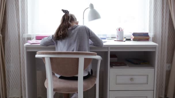 Little school girl doing homework — Stock Video