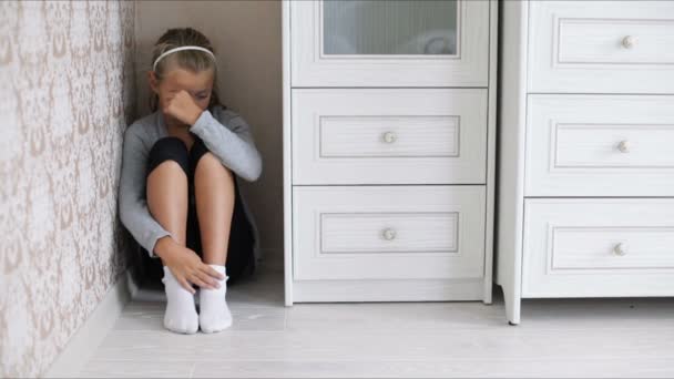 Little sad girl sitting on the floor — Stock Video