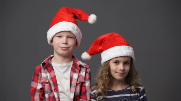 Niña y niño en gorras de Navidad — Vídeo de stock