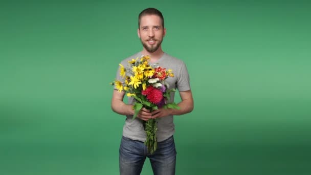 Young romantic man giving a bouquet of flowers — Stock Video