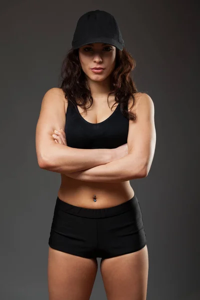 Young sports woman in a black top and shorts