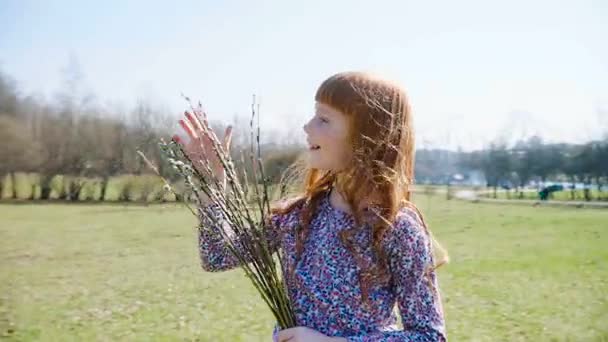 Мила дівчина з імбиром тримає пружинний пучок — стокове відео
