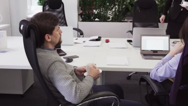 Деловые люди общаются во время кофе-брейка на рабочем месте в офисе — стоковое видео