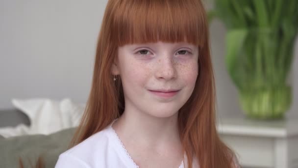 Little happy ginger girl with freckles in a white room — Stock Video