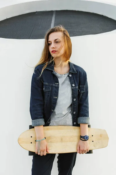 Portrait of woman with longboard Stock Picture