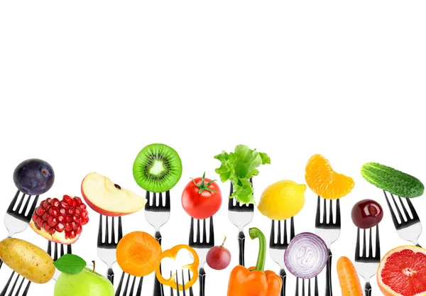 Fruits and vegetables on fork — Stock Photo, Image