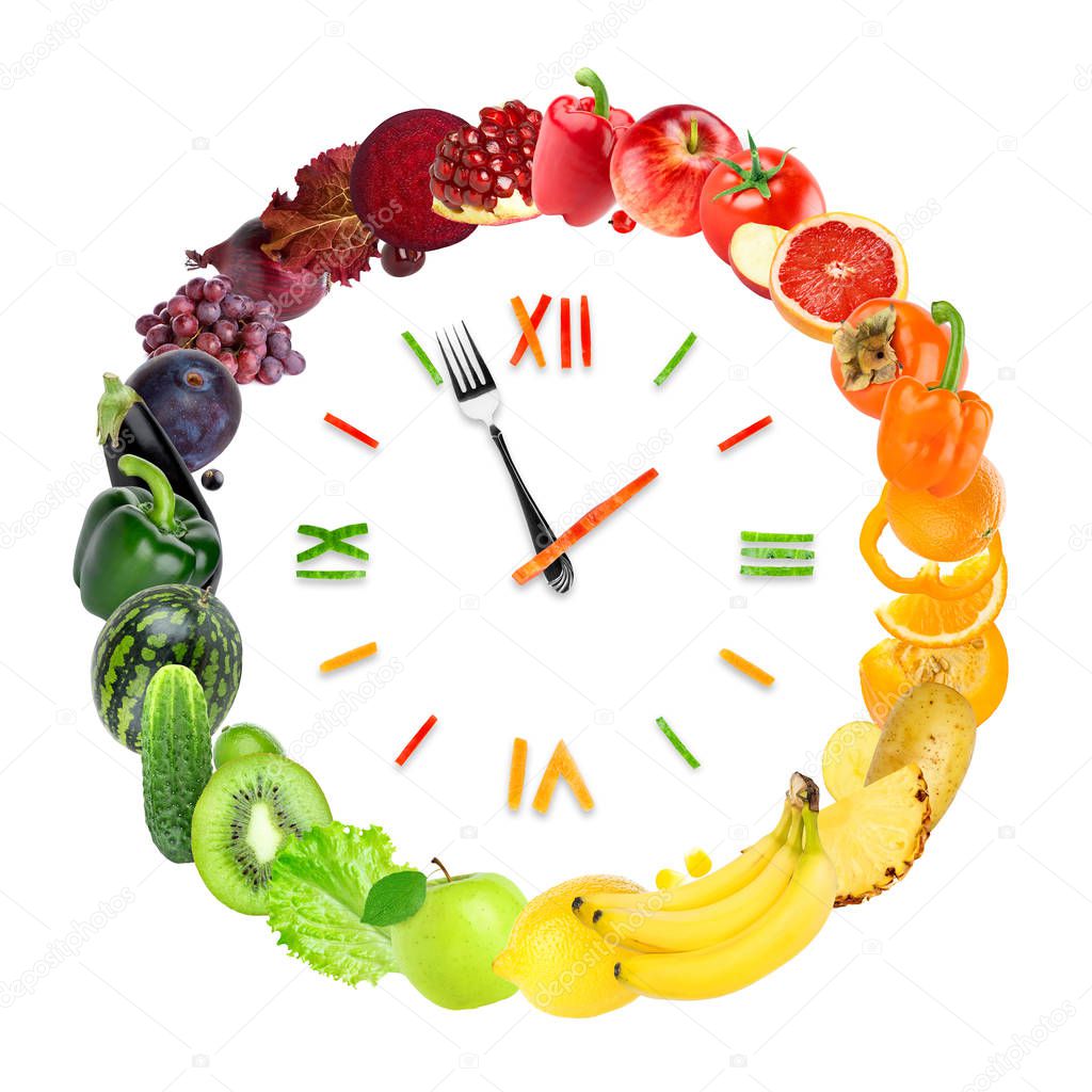 Food clock with fresh fruits and vegetables