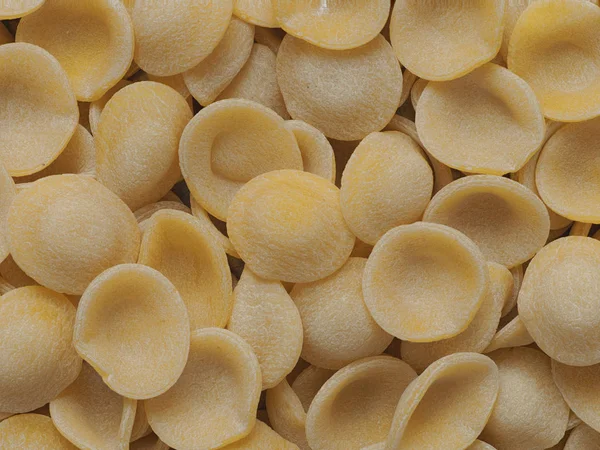 Dried italian orecchiette pasta food background — Stock Photo, Image