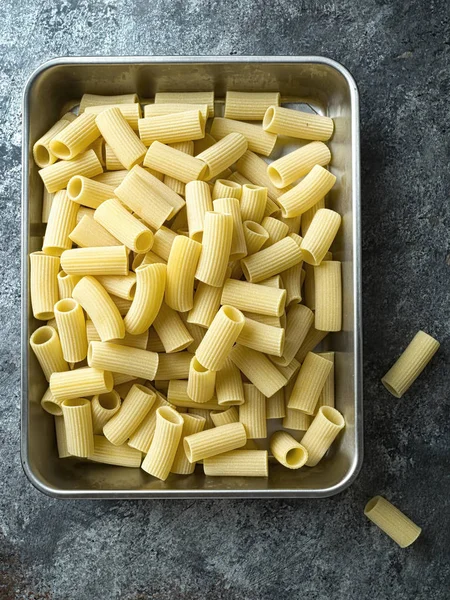 Rustic uncooked italian rigatoni pasta — стоковое фото