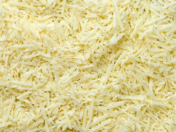 Finomra reszelt parmagiano reggiano sajt élelmiszer-háttér — Stock Fotó