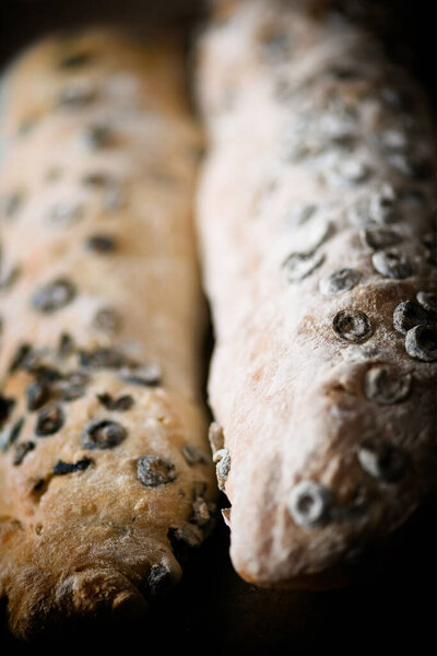 close up of rustic italian black olive ciabatta bread