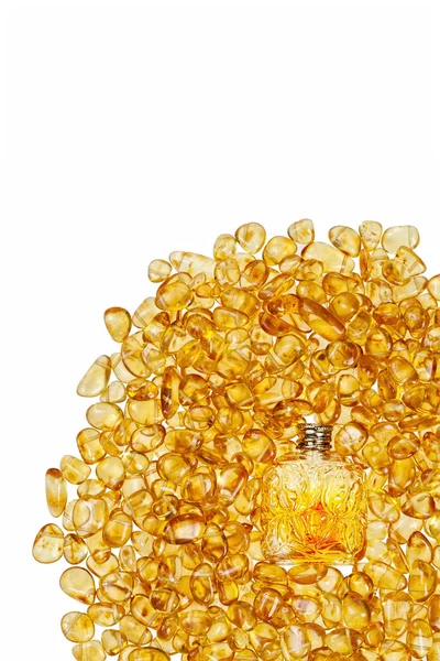 Vintage bottle and yellow amber stones. — Stock Photo, Image