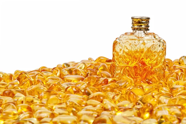 Vintage bottle and yellow amber stones. — Stock Photo, Image
