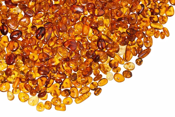 Dark yellow amber stones on a white background. — Stock Photo, Image