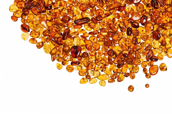 Dark yellow amber stones on a white background. — Stock Photo, Image