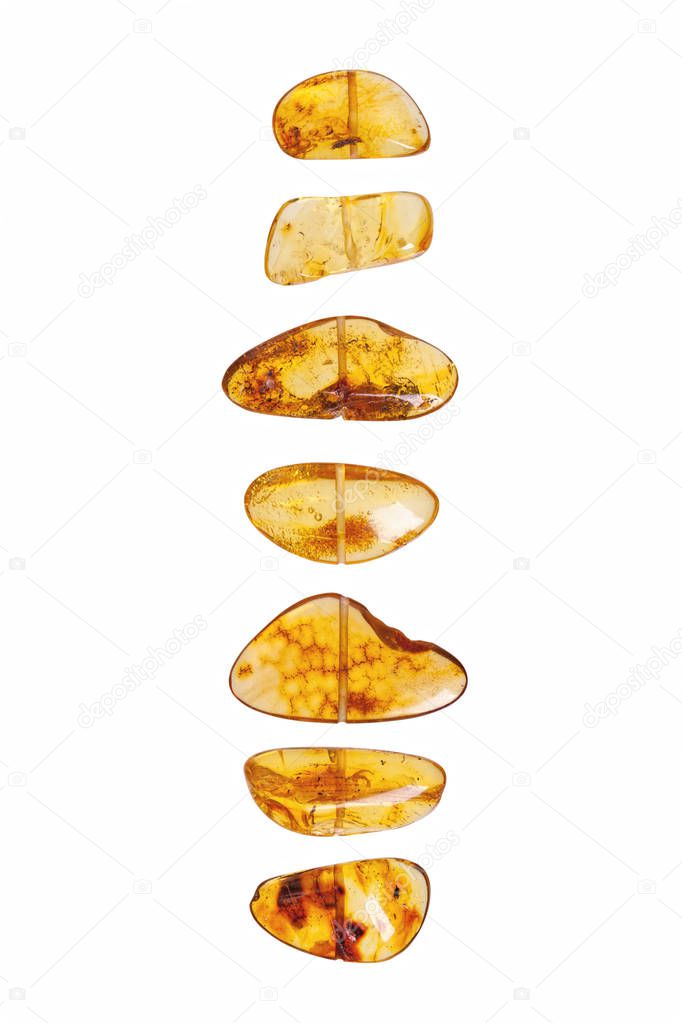 Yellow amber stones on a white background. 